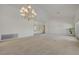 Spacious living room with chandelier, carpet, and view into another room at 2808 Crown Ridge Dr, Las Vegas, NV 89134