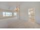 Bright living room with a view of the kitchen and a decorative chandelier at 2808 Crown Ridge Dr, Las Vegas, NV 89134