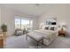 This bright and airy main bedroom features a large window and neutral colors at 2808 Crown Ridge Dr, Las Vegas, NV 89134