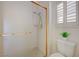 Bright bathroom featuring a tiled shower with gold fixtures and a small window at 2808 Crown Ridge Dr, Las Vegas, NV 89134