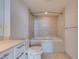 A cozy bathroom with built in soaking tub, tile surround and neutral vanity at 322 Karen Ave # 1106, Las Vegas, NV 89109