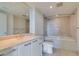 Bright bathroom with double sinks, a soaking tub, and tile surround at 322 Karen Ave # 1106, Las Vegas, NV 89109
