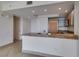 Modern kitchen with granite countertops, light wood cabinets, and stainless steel microwave at 322 Karen Ave # 1106, Las Vegas, NV 89109
