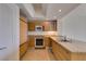 Kitchen features modern appliances, wood cabinetry, and granite countertops at 322 Karen Ave # 1106, Las Vegas, NV 89109