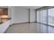 Living room showcasing tile flooring, neutral walls, and a large sliding glass door to the balcony at 322 Karen Ave # 1106, Las Vegas, NV 89109