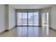 Bright, open living room with a large sliding glass door leading to a balcony with city views at 322 Karen Ave # 1106, Las Vegas, NV 89109