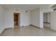An open living room with neutral walls, tile floors and multiple doors to other rooms at 322 Karen Ave # 1106, Las Vegas, NV 89109