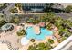 Aerial view of a resort-style pool with palm trees, rock features and seating areas at 322 Karen Ave # 1106, Las Vegas, NV 89109