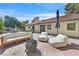 Outdoor living space featuring a brick patio, sofa, lounge chairs, and fire pit at 3220 Calle De El Cortez, Las Vegas, NV 89102