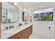Modern bathroom with double sinks, sleek fixtures, and a bright window offering natural light at 3220 Calle De El Cortez, Las Vegas, NV 89102