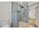 Tiled walk-in shower, modern fixtures, and a view into a bedroom with hardwood floors at 3220 Calle De El Cortez, Las Vegas, NV 89102