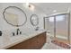 Modern bathroom features dual sinks, sleek fixtures, and a walk-in shower with sliding glass doors at 3220 Calle De El Cortez, Las Vegas, NV 89102