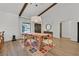 Bright dining room with wood floors, wooden table, pendant lighting and exposed beams on the ceiling at 3220 Calle De El Cortez, Las Vegas, NV 89102