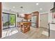 Modern kitchen with stainless steel appliances, wooden cabinets, tile backsplash, and wood-look floors at 3220 Calle De El Cortez, Las Vegas, NV 89102
