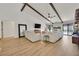 Spacious living room featuring wood floors, exposed beam ceiling, and large windows for natural light at 3220 Calle De El Cortez, Las Vegas, NV 89102