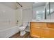 Bathroom featuring tub-shower combination, wooden vanity, and neutral decor at 350 S Durango Dr # 103, Las Vegas, NV 89145