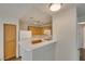 Bright kitchen featuring oak cabinets, sleek countertops, and modern lighting fixtures at 350 S Durango Dr # 103, Las Vegas, NV 89145