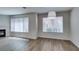 Inviting living room featuring wood-look floors, large windows, and a cozy fireplace at 350 S Durango Dr # 103, Las Vegas, NV 89145