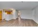 Spacious living room featuring wood-look floors and an open layout leading to the kitchen at 350 S Durango Dr # 103, Las Vegas, NV 89145