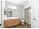 Bathroom featuring double vanity, shower and wood-look floors at 3608 Quetonia St # 204, Las Vegas, NV 89108