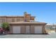 Exterior of apartment complex with garages and well-maintained grounds at 3608 Quetonia St # 204, Las Vegas, NV 89108