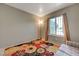 View of a neutral bedroom showcasing a colorful flower rug and natural light from the window at 3924 Blackford Pl, Las Vegas, NV 89102