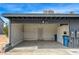 This is an open carport with the street number 3924, concrete floor, and blue trash cans at 3924 Blackford Pl, Las Vegas, NV 89102