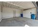 Open carport with concrete flooring, a metal gate, and white storage cabinets at 3924 Blackford Pl, Las Vegas, NV 89102