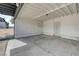 This is a covered carport with concrete flooring, a secure metal gate, and white storage cabinets at 3924 Blackford Pl, Las Vegas, NV 89102