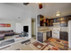 Open floor plan showcasing the living room with a TV and the kitchen with appliances and a sink at 3924 Blackford Pl, Las Vegas, NV 89102