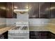 Kitchen details showcasing the gas range, granite countertops, and wooden cabinetry at 3924 Blackford Pl, Las Vegas, NV 89102