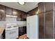 A kitchen showcasing a white refrigerator, stove, and cabinets with granite countertops at 3924 Blackford Pl, Las Vegas, NV 89102