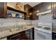 Kitchen with a stainless steel sink, granite counters, and range at 3924 Blackford Pl, Las Vegas, NV 89102