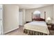 Inviting bedroom featuring a four-poster bed, arched window, and carpeted floor at 4050 Pacific Harbors Dr # 224, Las Vegas, NV 89121