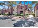 Multi-Gathering home with desert landscaping, mature trees, and a walkway leading to the units at 4050 Pacific Harbors Dr # 224, Las Vegas, NV 89121
