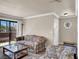 Inviting living room featuring a neutral color palette, plush floral seating, and slider to exterior at 4050 Pacific Harbors Dr # 224, Las Vegas, NV 89121