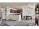 Living room and eat-in kitchen with stainless appliances, a breakfast bar, and a neutral color palette at 4050 Pacific Harbors Dr # 224, Las Vegas, NV 89121