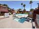 Community pool and jacuzzi area with lounge chairs, lush landscaping and plenty of sunshine at 4050 Pacific Harbors Dr # 224, Las Vegas, NV 89121