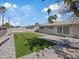 Wide-angle view of the backyard showcasing the manicured lawn and brick design, perfect for outdoor activities at 4204 El Jardin Ave, Las Vegas, NV 89102