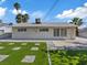 Exterior shot of the home showing a grass and stone backyard, ideal for outdoor living at 4204 El Jardin Ave, Las Vegas, NV 89102