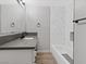 Modern bathroom featuring white vanity with a gray countertop and a tub with marble-style tiling at 4204 El Jardin Ave, Las Vegas, NV 89102