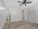 Bedroom featuring carpet flooring with a ceiling fan and an ensuite bathroom at 4204 El Jardin Ave, Las Vegas, NV 89102