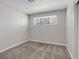 Bedroom showcasing carpet flooring, a neutral color palette, and bright window at 4204 El Jardin Ave, Las Vegas, NV 89102