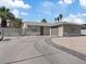 Single story home featuring a circular driveway, mature landscaping, and a two-car garage at 4204 El Jardin Ave, Las Vegas, NV 89102