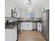 Updated kitchen boasts white cabinets, modern appliances, and grey countertops at 4204 El Jardin Ave, Las Vegas, NV 89102