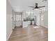 Open-concept living space features hardwood floors, modern lighting, and a kitchen with stainless steel appliances at 4204 El Jardin Ave, Las Vegas, NV 89102
