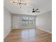 Open living area with hardwood floors, modern ceiling fan and lighting, and big bright windows at 4204 El Jardin Ave, Las Vegas, NV 89102