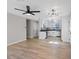 Open-concept living space features hardwood floors, modern lighting, and a kitchen with stainless steel appliances at 4204 El Jardin Ave, Las Vegas, NV 89102