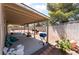 Backyard with a covered patio area, a blue grill, and a block wall fence at 4335 Twin Peaks Dr, North Las Vegas, NV 89032