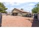 Wide view of backyard with covered patio and gravel area with block fence at 4335 Twin Peaks Dr, North Las Vegas, NV 89032